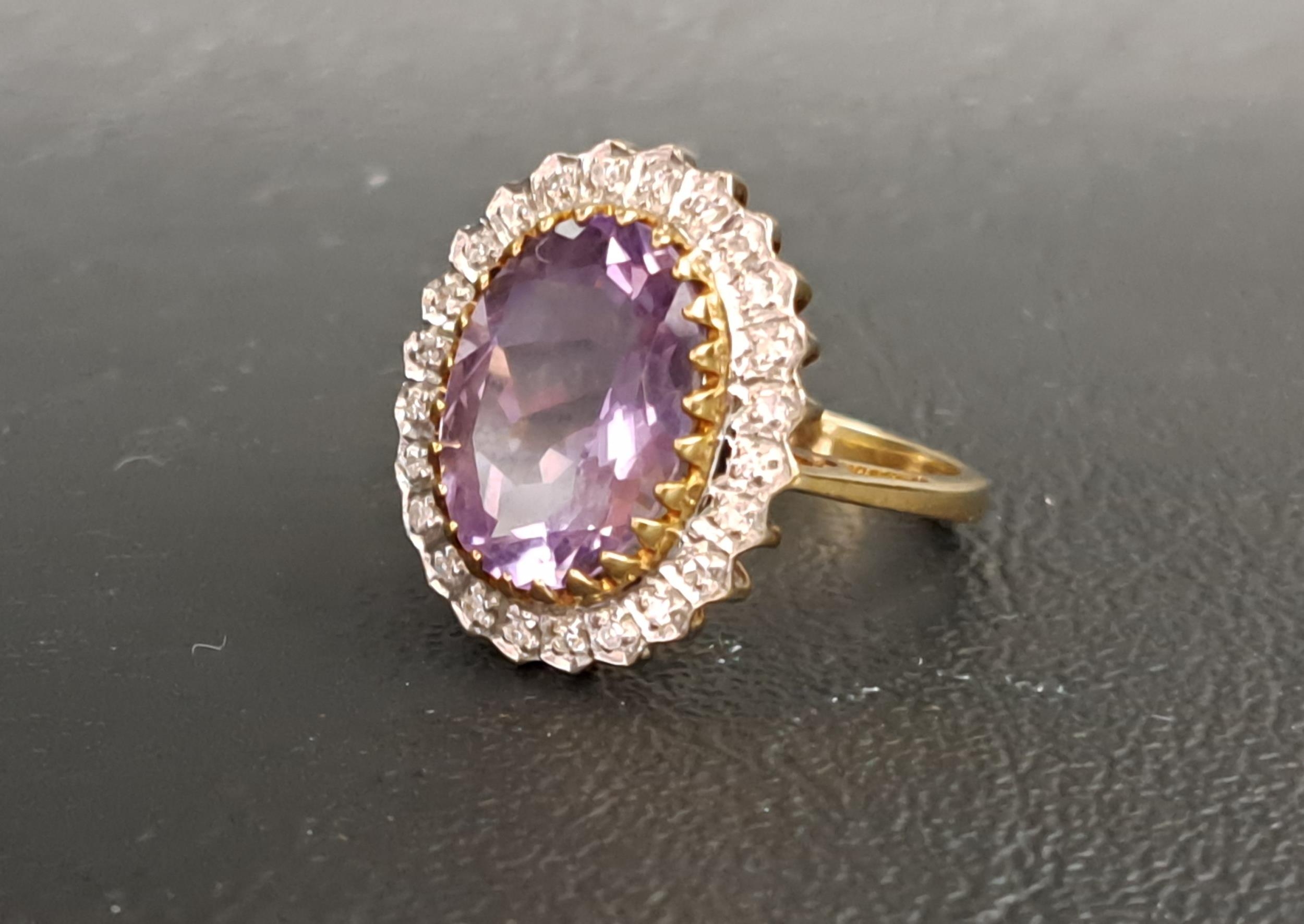 AMETHYST AND DIAMOND CLUSTER RING the central oval cut amethyst measuring approximately 14.1mm x - Image 2 of 2