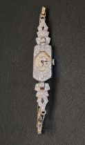 DIAMOND SET PLATINUM CASED COCKTAIL WATCH on nine carat white gold strap with further diamonds, in