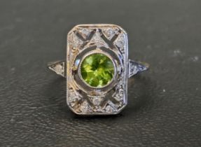 ART DECO STYLE PERIDOT AND DIAMOND PLAQUE RING the central round cut peridot approximately 1ct in