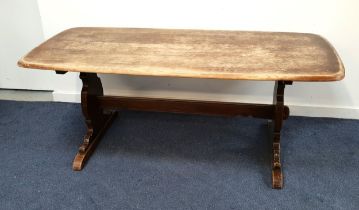 ERCOL ELM REFECTORY STYLE DINING TABLE standing on shaped end supports united by a stretcher, 72.5cm