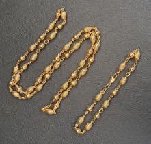 NINE CARAT GOLD NECKLACE AND MATCHING BRACELET both with alternating round and ribbed oval beads,