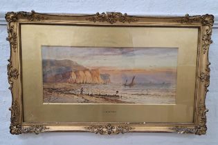 H.W. VERNON Beach scene with a man standing by the breakwater, watercolour, signed and label to