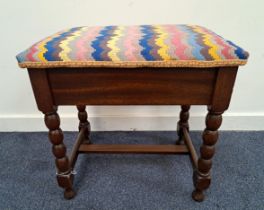 MAHOGANY PIANO STOOL with a padded lift up seat, on bobbin turned supports united by a stretcher,