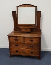 EDWARDIAN OAK DRESSING CHEST with an arch back and bevelled mirror above a central drawer, the