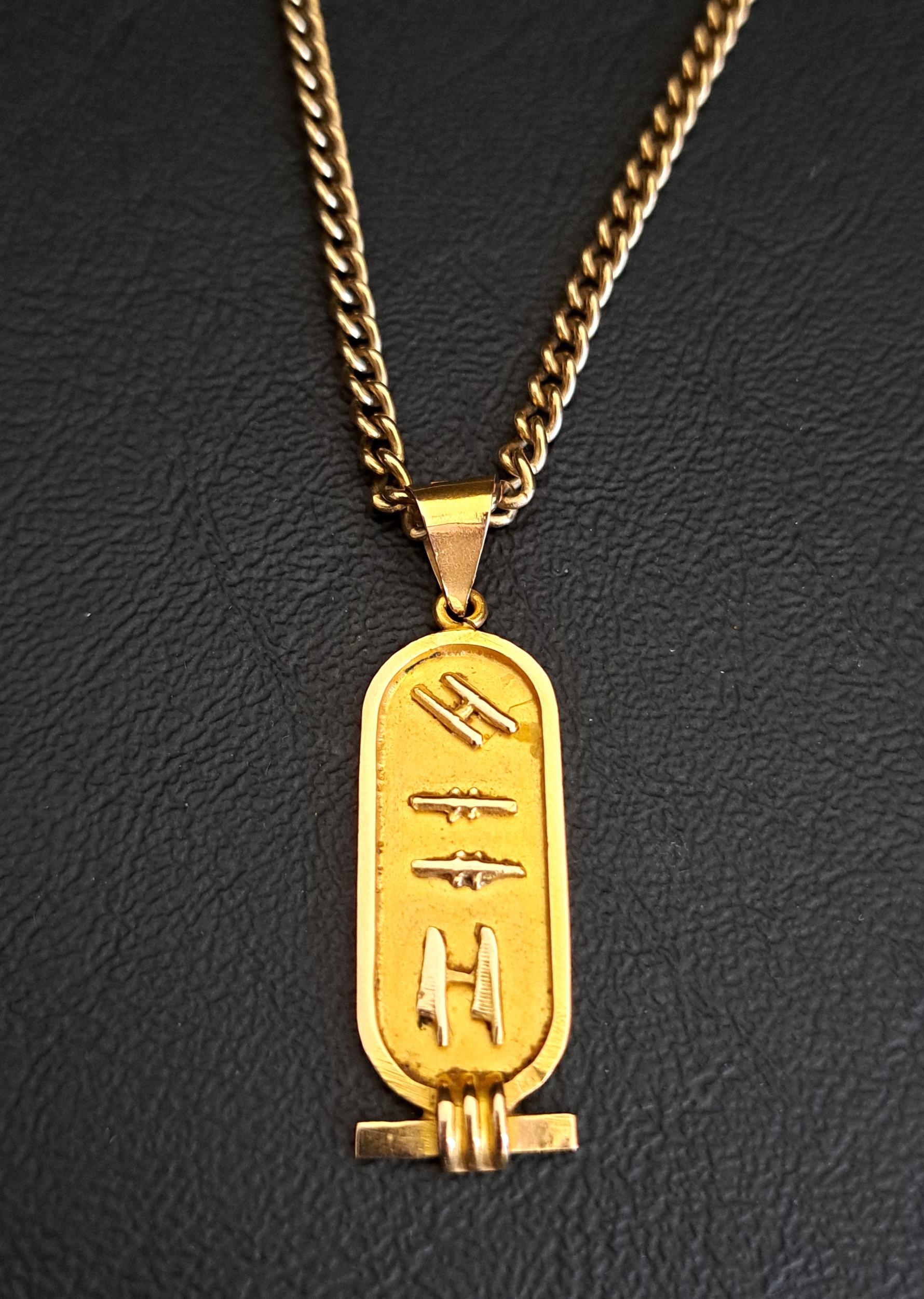 EGYPTIAN EIGHTEEN CARAT GOLD PENDANT decorated with hieroglyphs, 4.2cm high and approximately 3.6