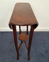 EDWARDIAN MAHOGANY OCCASIONAL TABLE with shaped drop flaps and fold out shaped supports united by an
