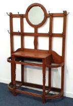 EDWARDIAN OAK HALL STAND with a central circular bevelled mirror on a lattice work of panels with
