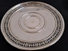 20th CENTURY SILVER SALVER raised on a circular foot with a pierced border, the base marked P.W.