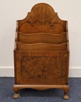 WALNUT AND CROSSBANDED MAGAZINE RACK with a shaped raised back above three divisions, standing on