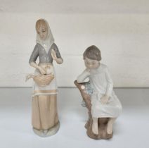 LLADRO FIGURINE OF A YOUNG BOY IN NIGHTDRESS seated on a tree stump, 21cm high; together with a
