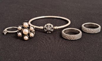 SELECTION OF PANDORA SILVER JEWELLERY comprising snowflake clasp bangle, and four rings -