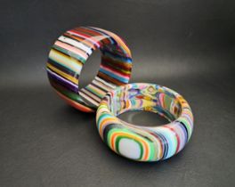 TWO SOBRAL RESIN BANGLES of colourful striped design, 4.8cm and 3.3cm wide respectively