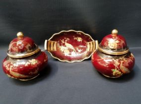 CARLTON WARE ROUGE ROYALE comprising a boat shaped pin dish and a pair of lidded jars (3)