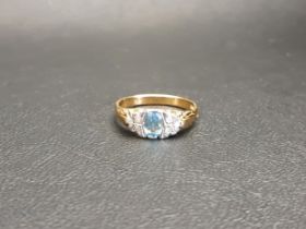 BLUE TOPAZ AND DIAMOND RING the central oval cut topaz approximately 0.5cts flanked by three