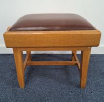 LIGHT OAK PIANO STOOL with a padded vinyl adjustable seat flanked by winding handles, standing on