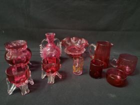 SELECTION OF CRANBERRY AND RUBY GLASS comprising a pair of salts, small jug, frill rim squat vase,