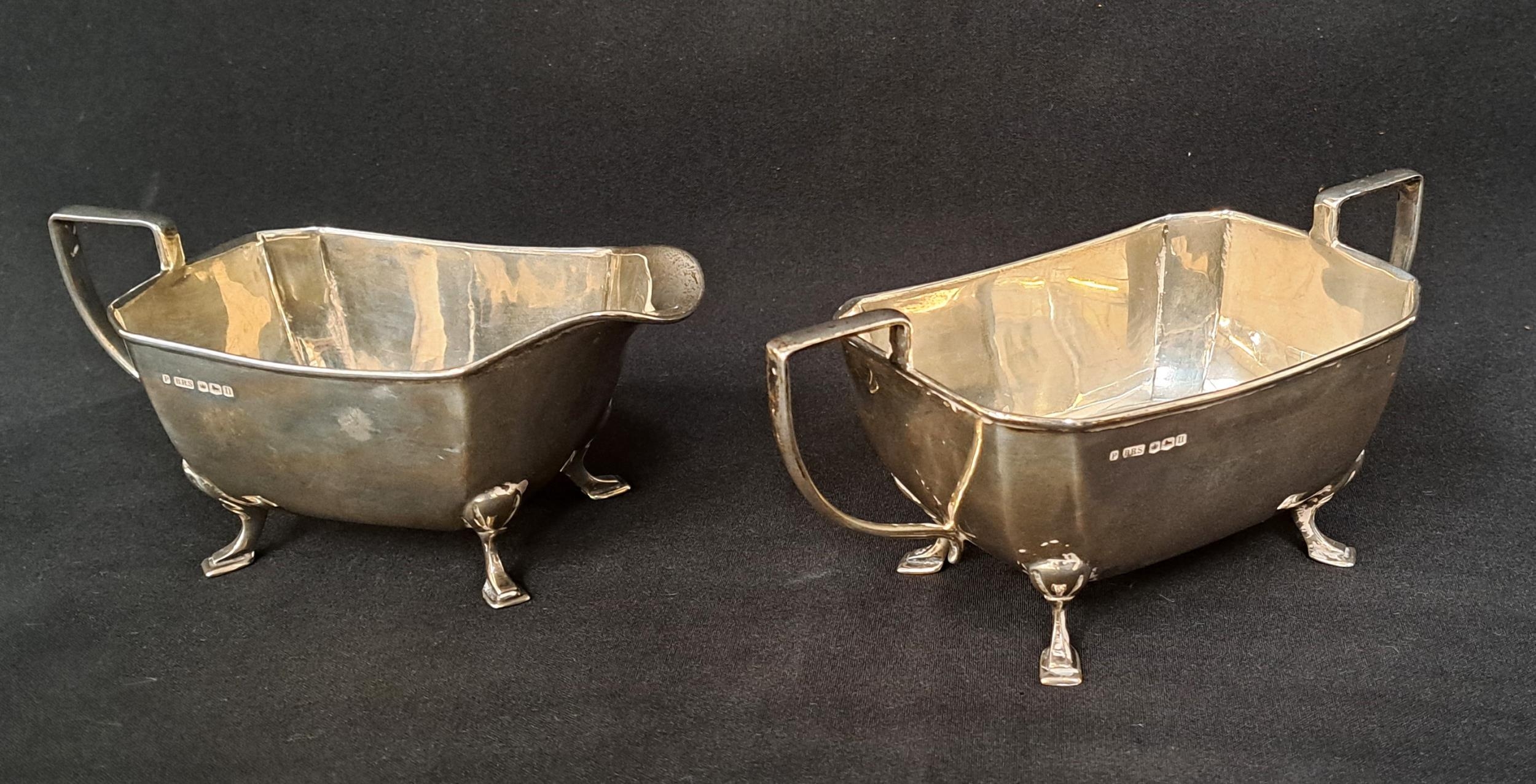 GEORGE V SILVER MILK JUG AND SUGAR BOWL both with canted corners and raised on square pad feet,