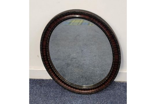 VICTORIAN OVAL WALL MIRROR with bevel edge and snakewood and ebonised frame with textured detail, 59