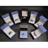 EIGHT VARIOUS GEM SET SILVER RINGS of various sizes and designs, including a diamond cluster ring,