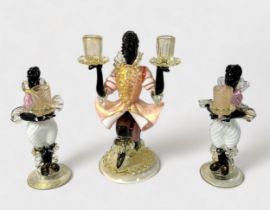 A garniture of Murano Glass Blackamoor figural candlesticks, pink, white and black glass with gold