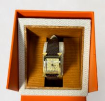 A ladies gold-plated Hermes wristwatch, model ‘HH1.201’, the textured dial with gilt decoration