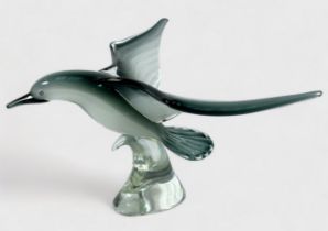 A Murano style glass sculpture of a seagull in flight, raised on naturalistic glass base modelled as