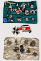 Twenty-two German Third Reich 'style' metal and enamel badges and an Iron Cross, together with