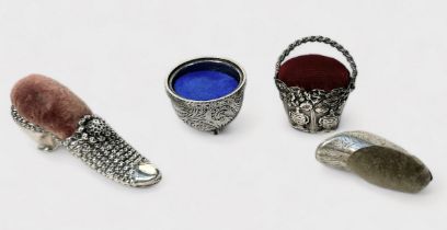Four various novelty pin cushions including a silver example modelled as a shoe, makers marks ‘