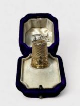 An Edwardian 15ct gold thimble, typical dimled crown and skirt with foliate chased snd ebngraved
