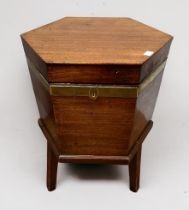 A 19th Century mahogany and brass bound wine cellarette, of hexagonal form, hinged lift open top