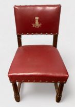 A red leather upholstered oak dining chair, bearing gilt-tooled insignia of the British Army Staff