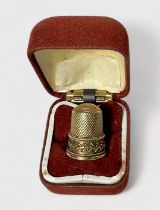 An unmarked Edwardian gold thimble, testing as 14-15ct gold, dimpled crown and diamond-dimpled