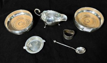 A pair of silver bottle coasters with turned wooden bases, together with an Arts & Crafts spoon with