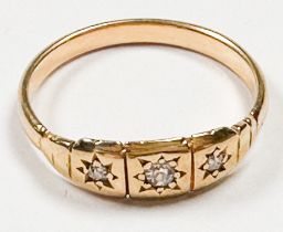 An 18ct yellow gold dress ring, star set with three Victorian cut diamonds in a square grooved
