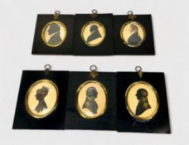 A collection of six 19th Century oval silhouettes and portrait miniatures, bust length in profile,
