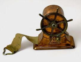 A Novelty brass and copper Tape Measure modelled as a Ship's Wheel, Rd.128885, 4cm high