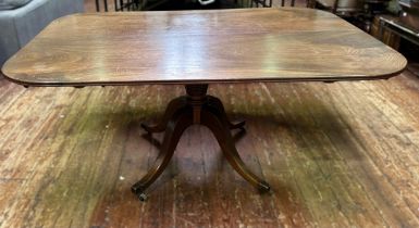 A Regency mahogany shaped-rectangular tilt-top table, on ring turned tapering stem, quadripartite