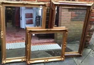 Three various modern parcel-gilt framed mirrors of rectangular form, with ornate scrolled and