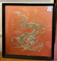 A Chinese silk embroidery depicting a dragon to a salmon ground, framed, 47 x 44cm, together with