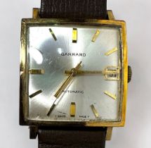 A 9ct gold cased automatic wristwatch by Garrard, the square silvered dial with applied gilt