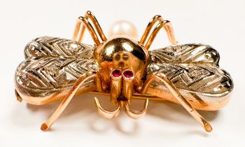 An 18ct yellow gold brooch styled as a flying insect, bezel -set ruby eyes and single cultured pearl