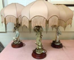 Three various Giuseppe Armani resin figural lamps modelled as women, raised on turned wooden