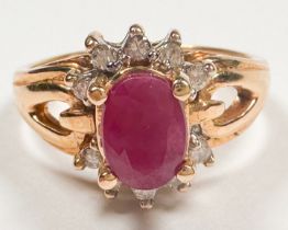 A 14ct yellow gold dress ring, four-claw set with an oval shaped ruby to the centre, measuring 7mm x