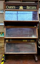 An early 19th Century Carr's Biscuits shop display cabinet, three tiered mahogany and pine storage