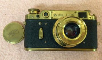 A reproduction Leica Berlin 1936 camera, no.173276, in fitted and branded brown leather case, with a