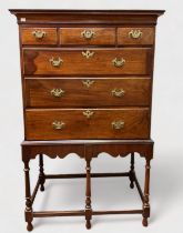 A George III mahogany chest on associated later stand, of three short and three long graduated