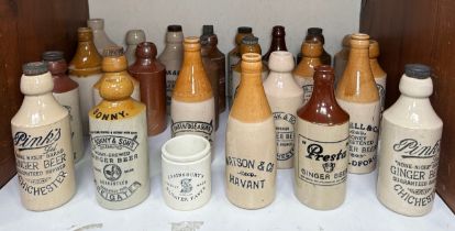 Twenty-four various stoneware ginger beer bottles, including local interest examples, six Pink’s ‘