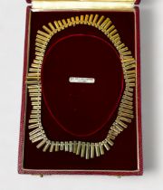 A 9ct gold necklace of undulating fringe design, 37.47g, in fitted retail box