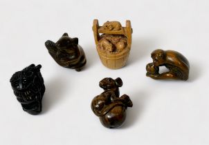 Five various Japanese carved and stained boxwood Netsuke, signed, including monkey holding a