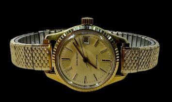 A ladies 18ct gold cased Jean Renet ‘Daymatic’ automatic wristwatch, the champagne dial with applied